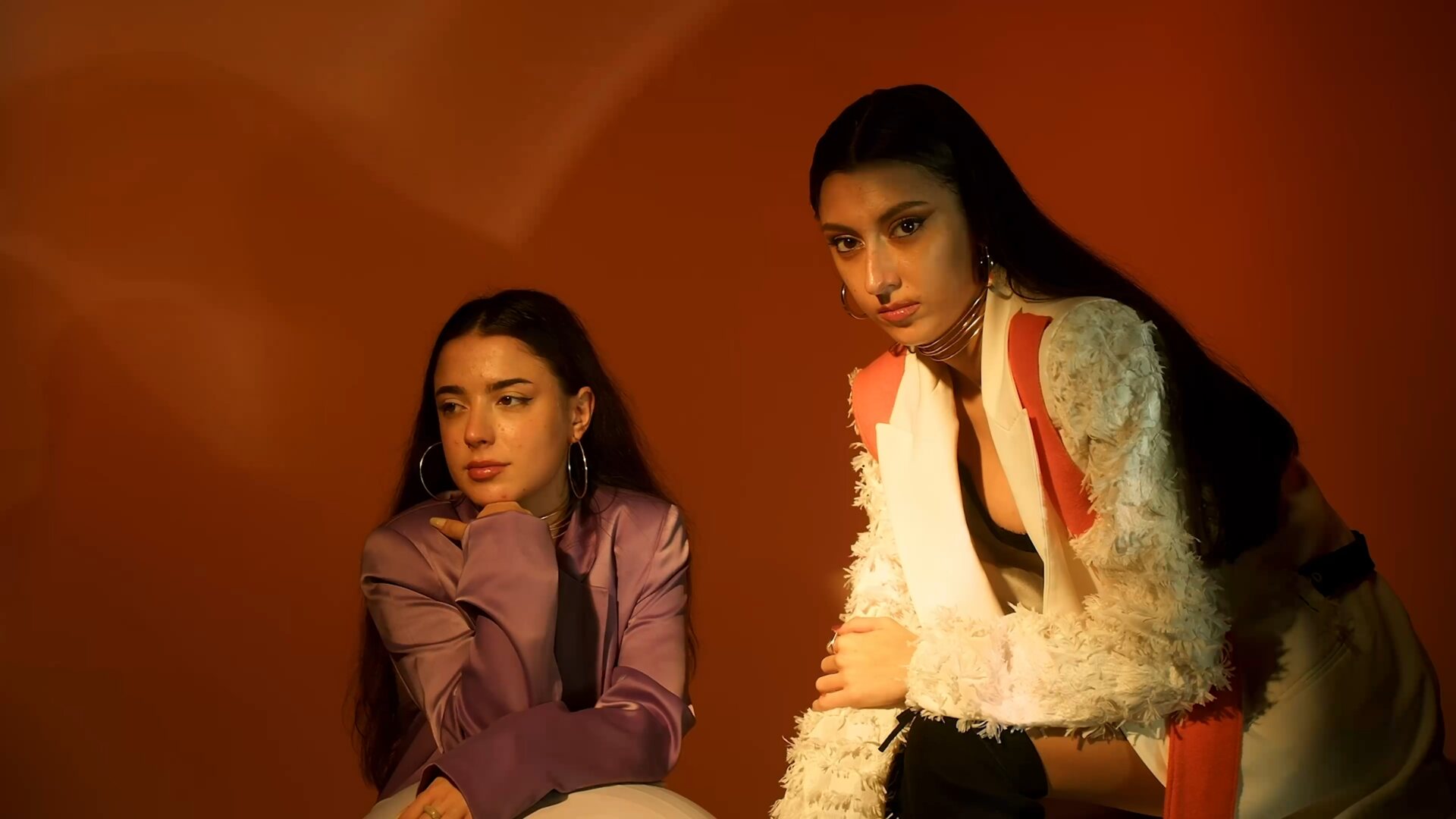 Shadow projected on warm orange wall — light as compositional protagonist