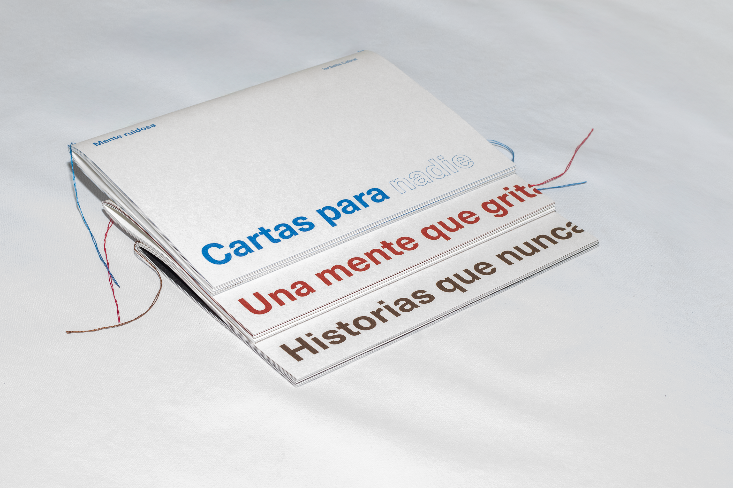 The three coloured covers — blue, red and sepia